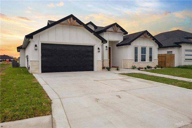 556 Demi St, Edinburg, TX 78542 - modern farmhouse style home featuring a lawn, board and batten siding, stone siding, and an attached garage