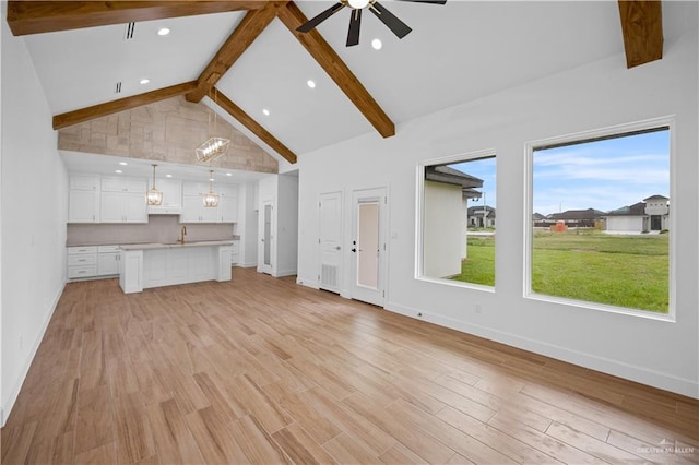 556 Demi St, Edinburg, TX 78542 - unfurnished living room featuring baseboards, beam ceiling, and a ceiling fan