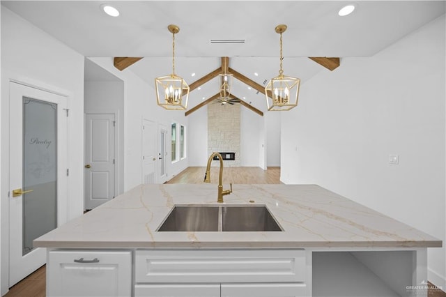 556 Demi St, Edinburg, TX 78542 - kitchen featuring recessed lighting, a sink, open floor plan, white cabinets, and vaulted ceiling with beams
