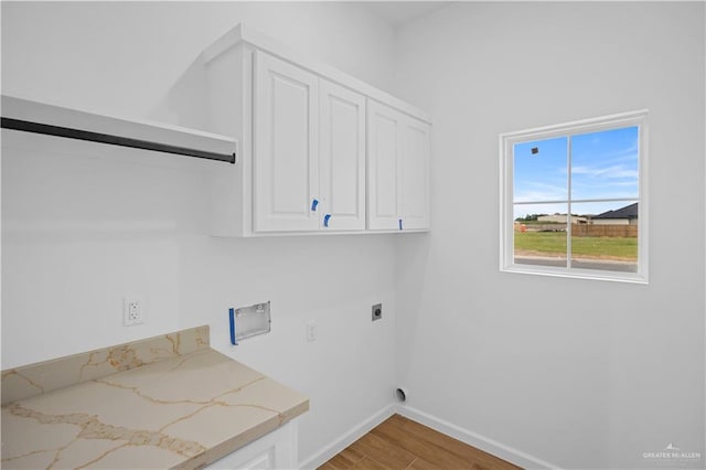 556 Demi St, Edinburg, TX 78542 - washroom with cabinet space, hookup for an electric dryer, hookup for a washing machine, baseboards, and light wood-style floors