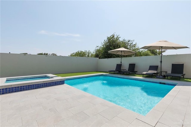 view of swimming pool with a fenced in pool, fence, a patio, and an in ground hot tub