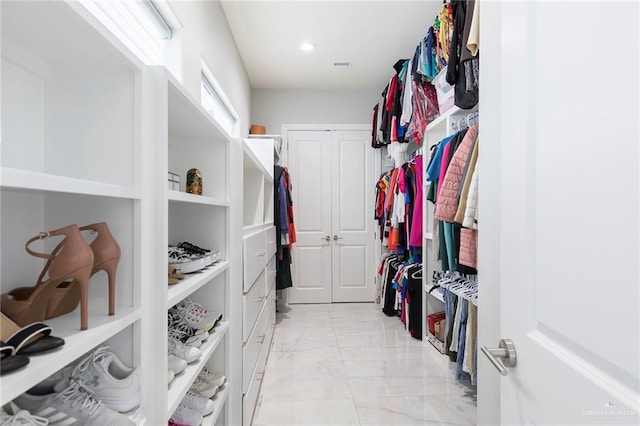 spacious closet featuring marble finish floor