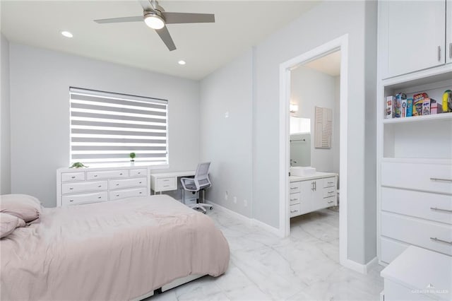 bedroom featuring a ceiling fan, baseboards, marble finish floor, and ensuite bath