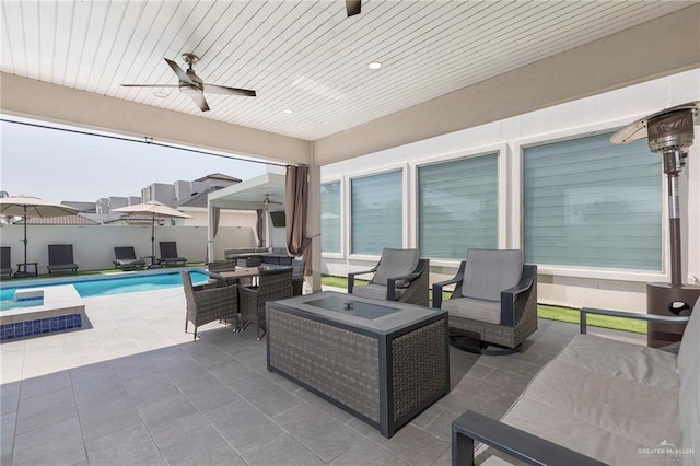 view of patio featuring fence, a ceiling fan, an outdoor hangout area, and a fenced in pool