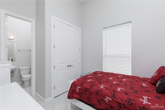 bedroom with marble finish floor and ensuite bath