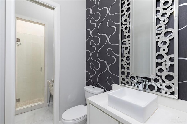 bathroom featuring toilet, a shower stall, marble finish floor, and vanity