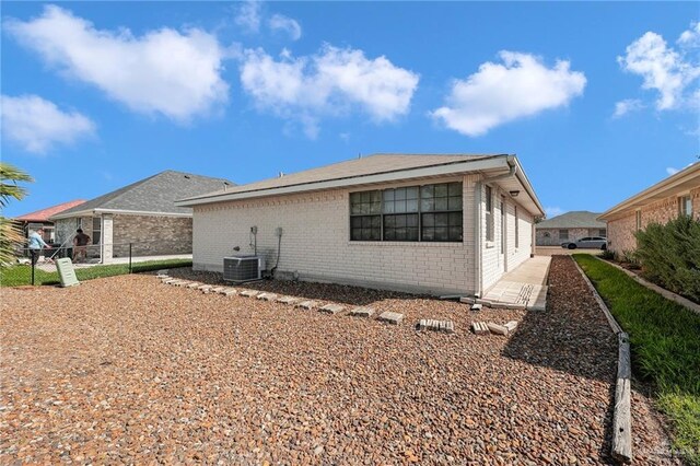 1700 Aries St, Mission, TX 78572 - rear view of house with brick siding