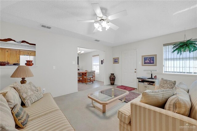 1700 Aries St, Mission, TX 78572 - living area featuring light colored carpet, a chandelier, a ceiling fan, and a textured ceiling