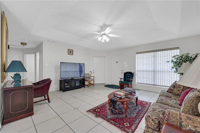 1700 Aries St, Mission, TX 78572 - living area with a raised ceiling, a textured ceiling, a ceiling fan, and light tile patterned floors