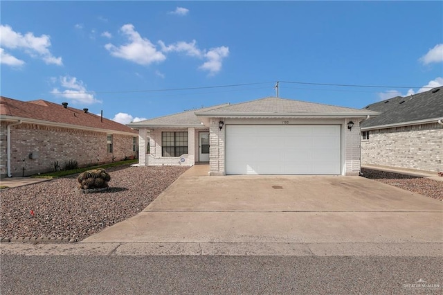 1700 Aries St, Mission, TX 78572 - ranch-style house featuring driveway, a garage, and brick siding