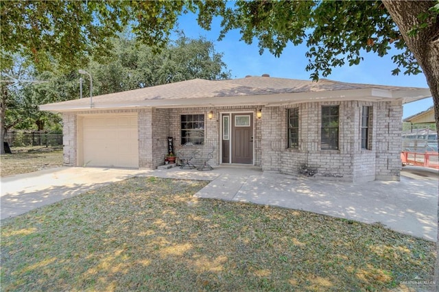 ranch-style home featuring concrete driveway and a garage