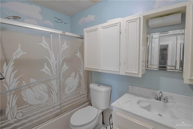 bathroom featuring toilet, bath / shower combo with glass door, and vanity