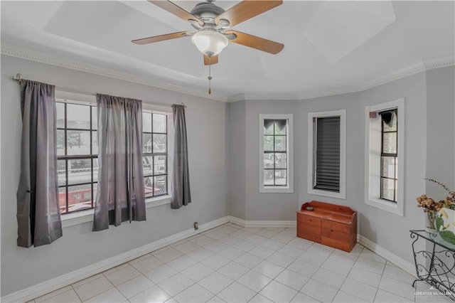 empty room with a ceiling fan, baseboards, ornamental molding, and a healthy amount of sunlight