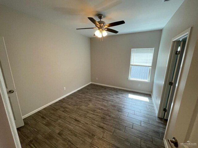 empty room with ceiling fan and dark wood-type flooring