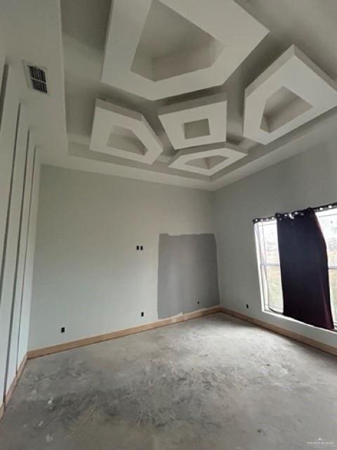 unfurnished room with concrete flooring and coffered ceiling