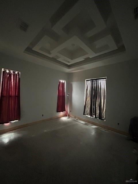 unfurnished room with coffered ceiling