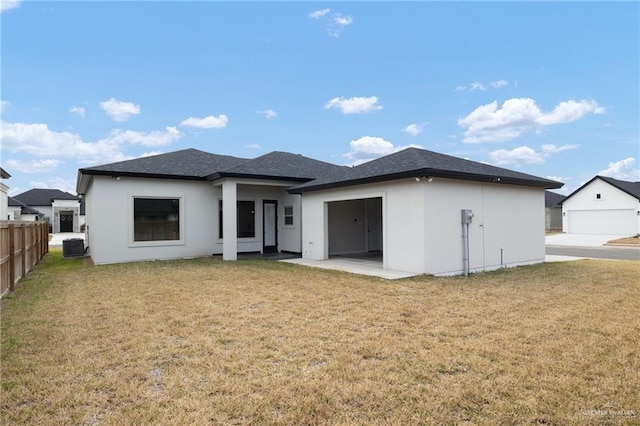 rear view of house with a patio area, central air condition unit, and a lawn