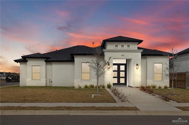 prairie-style home with a yard