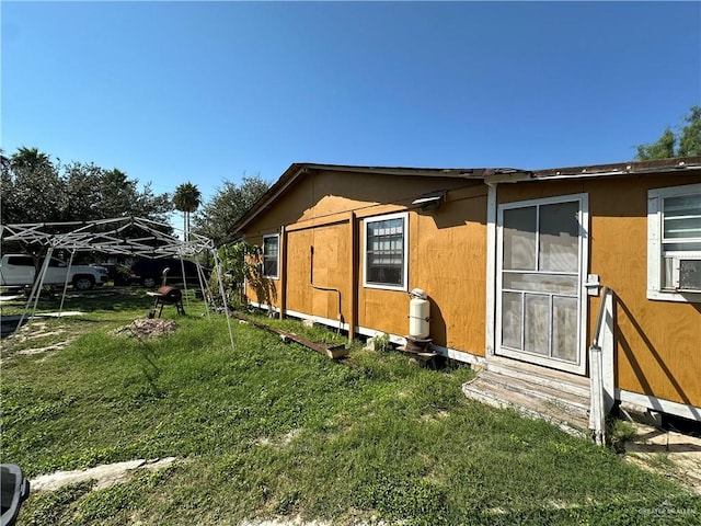 view of side of home featuring a lawn