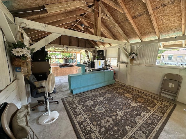 interior space featuring concrete floors and lofted ceiling