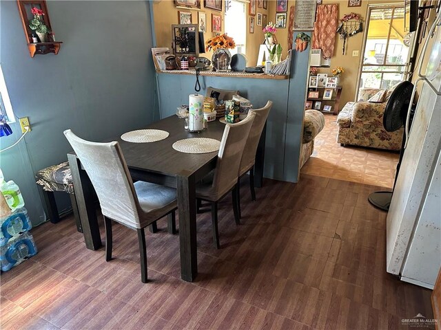 dining space featuring dark wood-type flooring