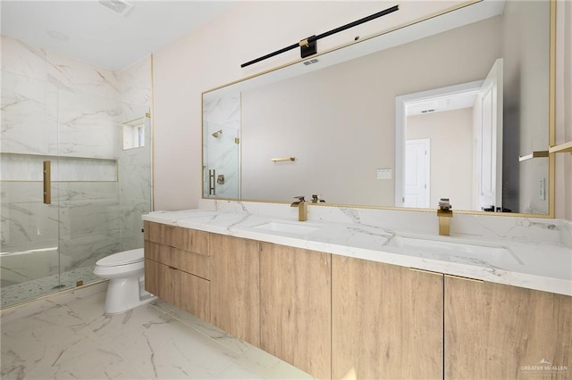 bathroom featuring vanity, an enclosed shower, and toilet