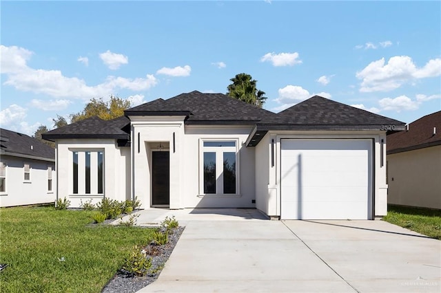 prairie-style home with a front yard and a garage