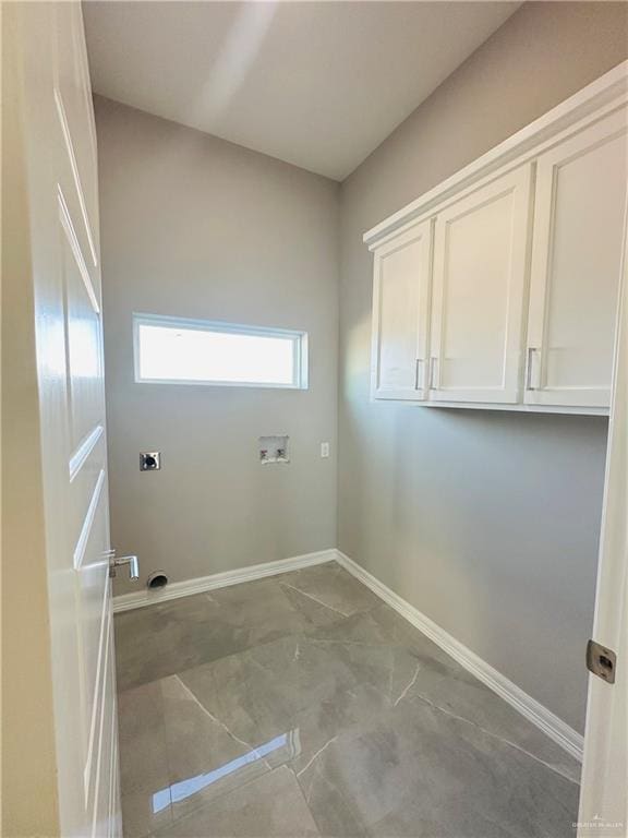 laundry area featuring cabinets, hookup for a washing machine, and hookup for an electric dryer