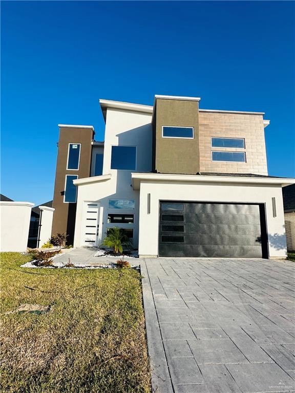 modern home with a front yard and a garage