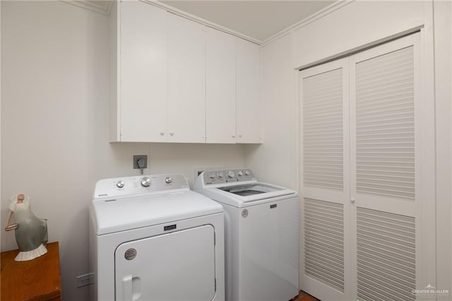 laundry room with cabinets, washer and dryer, and crown molding