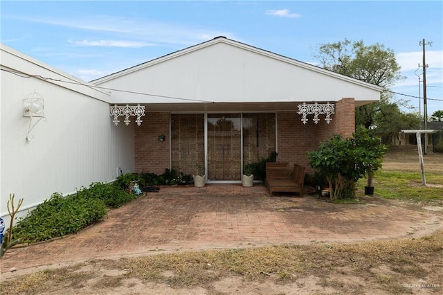 doorway to property featuring a patio area