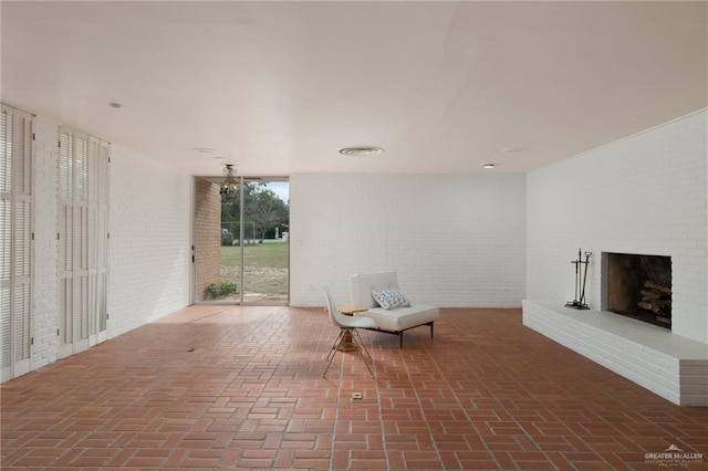 view of patio with a brick fireplace