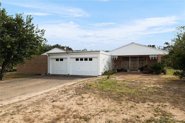 single story home featuring a garage and covered porch