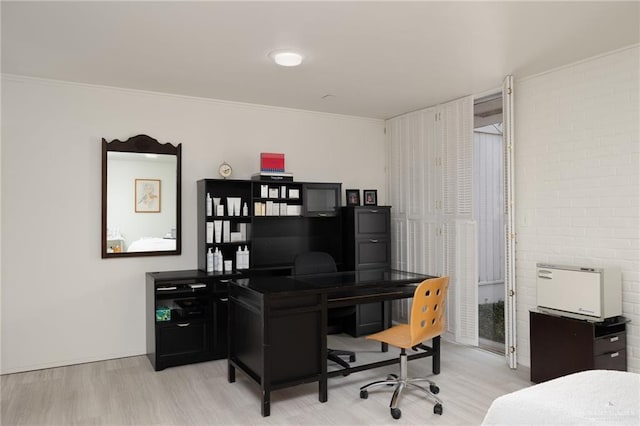 office area with ornamental molding and light hardwood / wood-style flooring