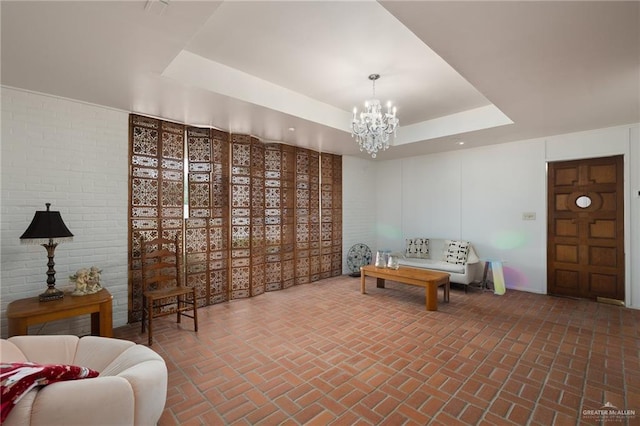 interior space with a tray ceiling and a notable chandelier