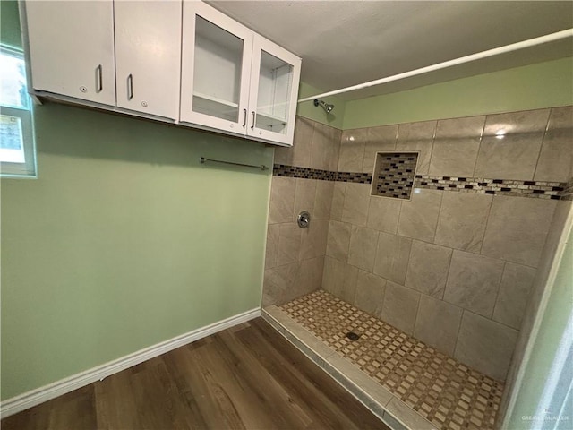 512 S 24th St, Donna, TX 78537 - full bath with tiled shower, wood finished floors, and baseboards