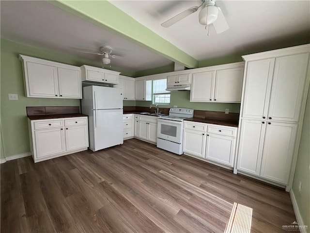 512 S 24th St, Donna, TX 78537 - kitchen with white appliances, ceiling fan, under cabinet range hood, dark countertops, and white cabinetry