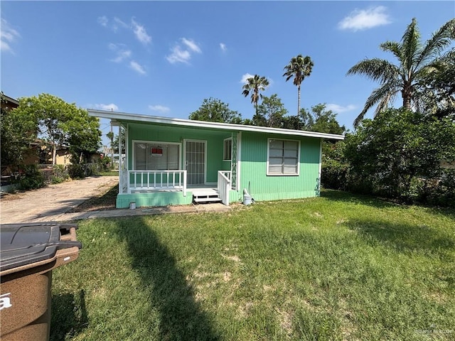 512 S 24th St, Donna, TX 78537 - view of front of home with covered porch and a front lawn