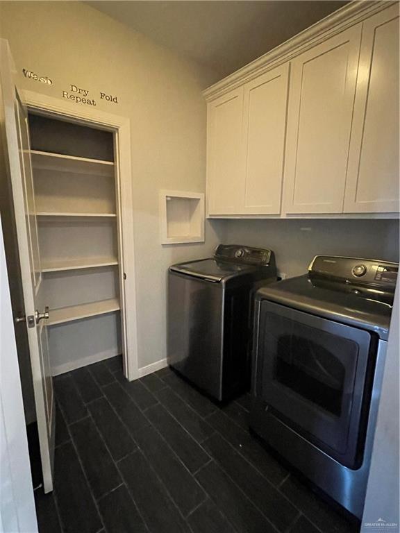 laundry room featuring cabinets, separate washer and dryer, and dark hardwood / wood-style floors