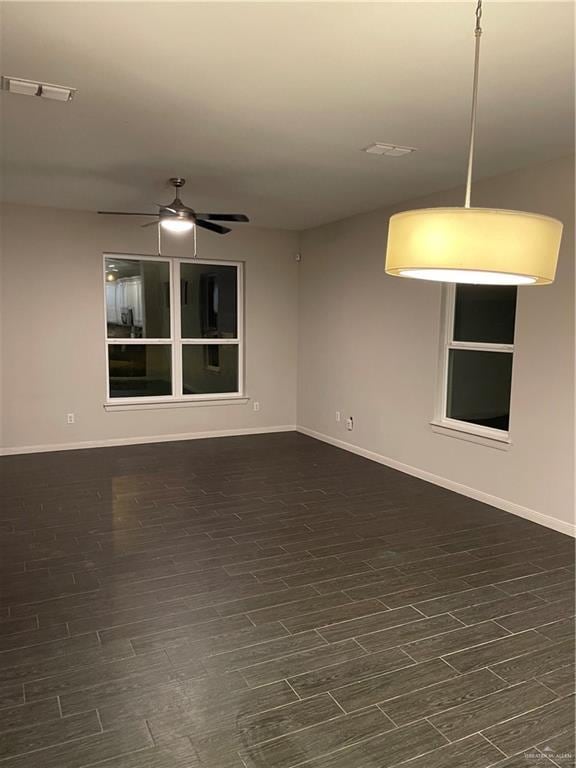 unfurnished room with dark hardwood / wood-style floors and ceiling fan