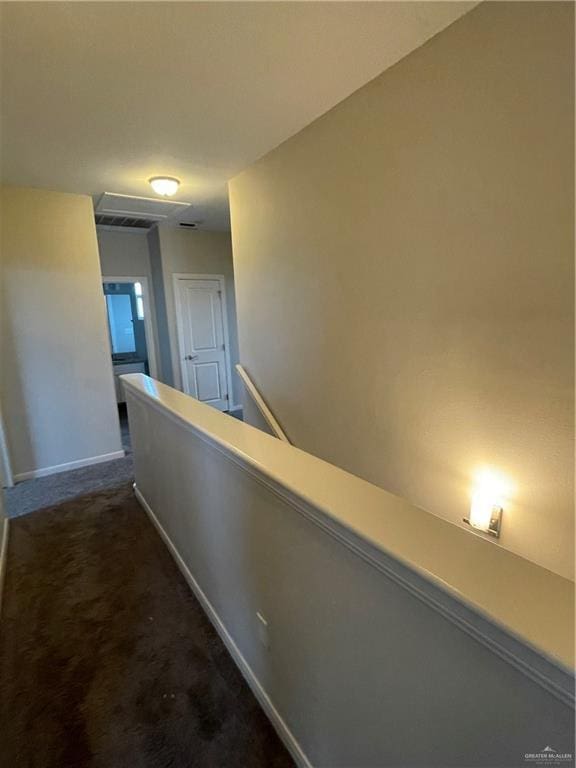 hall with dark carpet