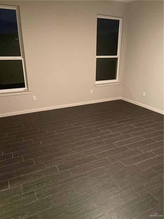 spare room with dark hardwood / wood-style flooring