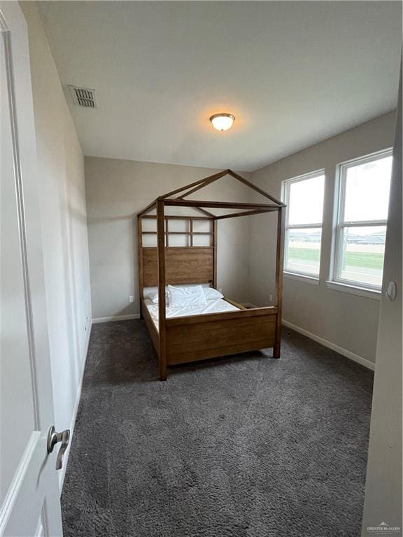 unfurnished bedroom featuring dark colored carpet