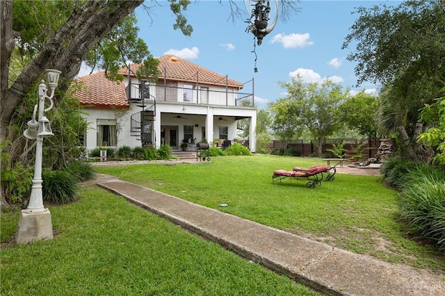 912 Bentsen Rd, Mcallen, TX 78501 - back of house featuring a balcony, stucco siding, a tile roof, ceiling fan, and a patio