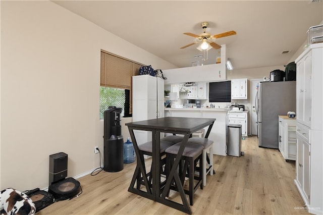 912 Bentsen Rd, Mcallen, TX 78501 - kitchen featuring white cabinets, light wood-style floors, light countertops, ceiling fan, and freestanding refrigerator