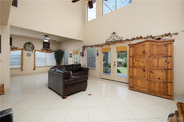 912 Bentsen Rd, Mcallen, TX 78501 - living area featuring a ceiling fan, french doors, a towering ceiling, light tile patterned floors, and baseboards