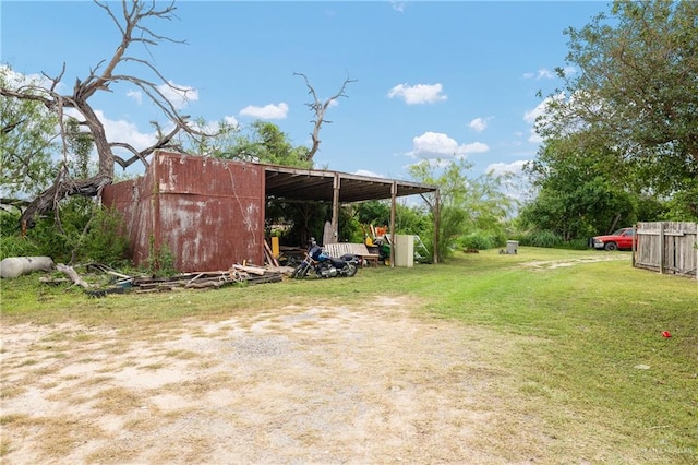912 Bentsen Rd, Mcallen, TX 78501 - view of green lawn featuring a pole building and an outdoor structure