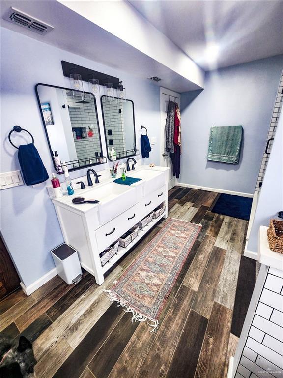 1405 S Brier St, Alton, TX 78573 - full bath with wood finished floors, double vanity, and a tile shower