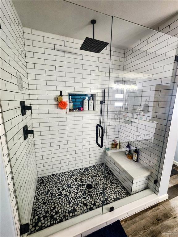 1405 S Brier St, Alton, TX 78573 - bathroom with wood finished floors and a stall shower