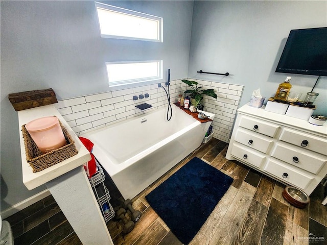 1405 S Brier St, Alton, TX 78573 - bathroom featuring a tub and wood finished floors